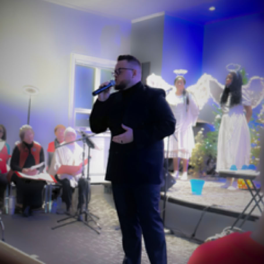 A mother and son kneeling and praying together inside a serene church.